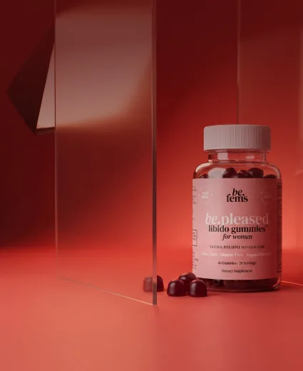 be.fems be.pleased libido gummies bottle on a red studio backdrop